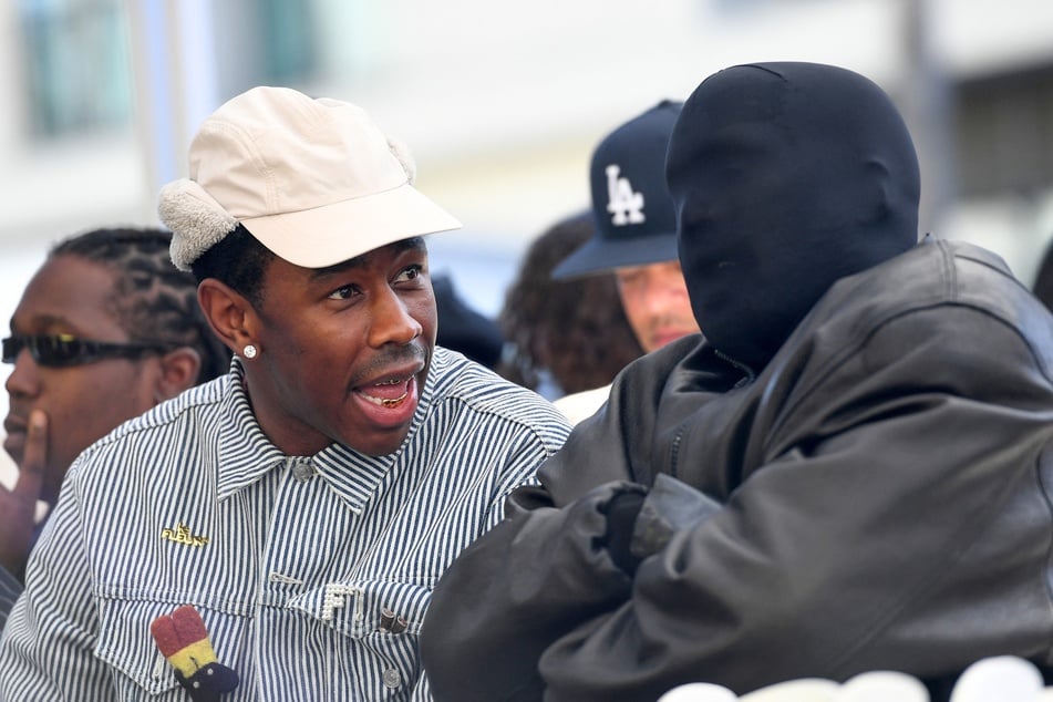 Controversial rapper Kanye West (r) got into a heated moment with a TMZ photographer after he was asked a question about his wife, Bianca Censori.