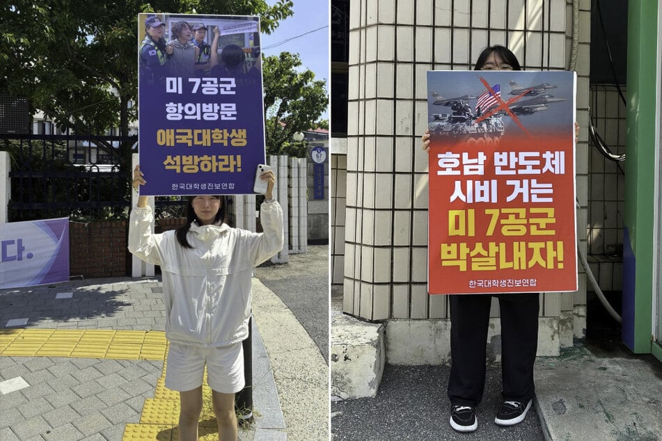 Young South Koreans hold up signs as they protest the US military presence in the country.