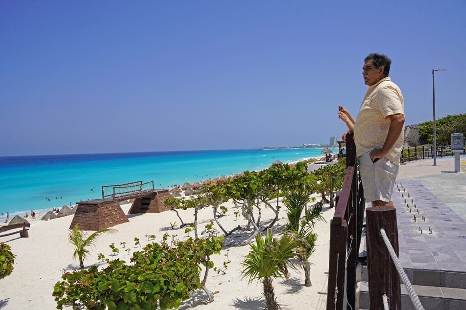 A man looks out to sea at a beach before the potential arrival of Hurricane Beryl in Cancun, Quintana Roo State, Mexico.