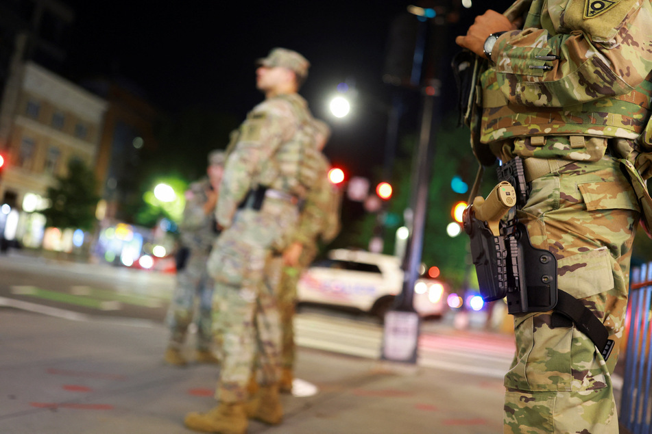 Members of the Ohio National Guard wear their sidearms while patrolling in the Logan Circle neighborhood of Washington DC on August 24, 2025.