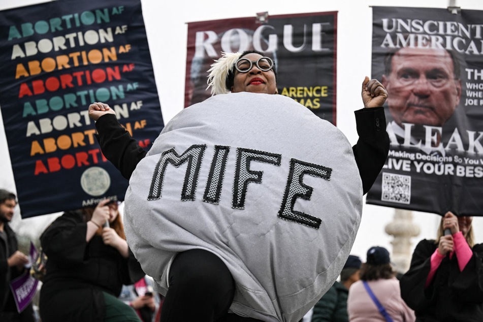 A woman dressed as a mifepristone pill dances with supporters of Planned Parenthood and pro-choice activists during a rally outside the US Supreme Court on April 2, 2025, in Washington, DC.