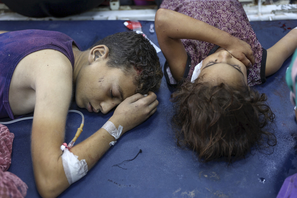 Children who were injured during an Israeli attack on the Jabalia refugee camp in the northern Gaza Strip receive treatment at Al-Ahli Arab hospital.