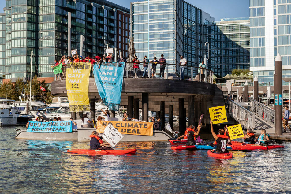 Protesters showed up at Senator Joe Manchin's yacht in the Washington marina as he continues to block Joe Biden's agenda.