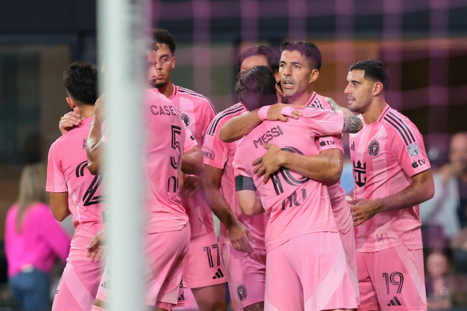 Inter Miami CF forward Luis Suarez celebrates with forward Leo Messi and teammates after scoring against FC Cincinnati during the second half at Nu Stadium.