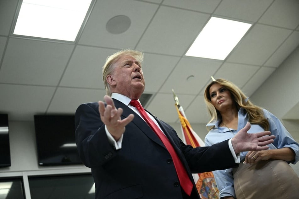 President Donald Trump (l.) and First Lady Melania Trump speak to the press at the Palm Beach County Supervisor of Elections office after voting early in the midterm elections. Trump said he "very much" voted along Republican Party lines.