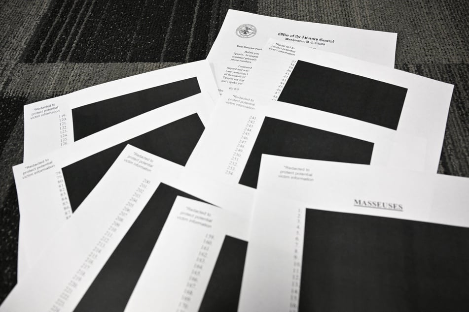 This photo illustration taken in Washington, DC, on December 19, 2025 shows redacted documents after the US Justice Department began releasing the long-awaited records from the investigation into the politically explosive case of convicted sex offender Jeffrey Epstein.