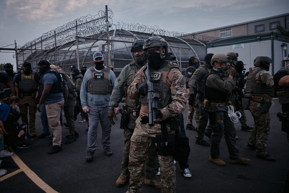 Federal agents threaten protesters outside Delaney Hall on June 13, 2025.