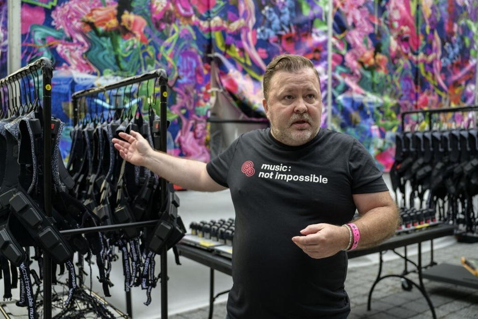 Patrick Hanlon, co-founder of Music: Not Impossible, shows off haptic suits created for the deaf during an outdoor concert at the Lincoln Center.