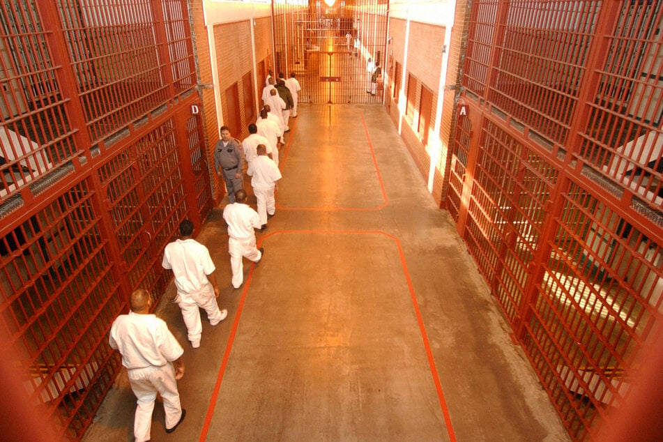 People incarcerated at the Darrington Prison Unit – renamed the Memorial Unit – in Rosharon, Texas, walk down the main hall on their way to the recreation yard.