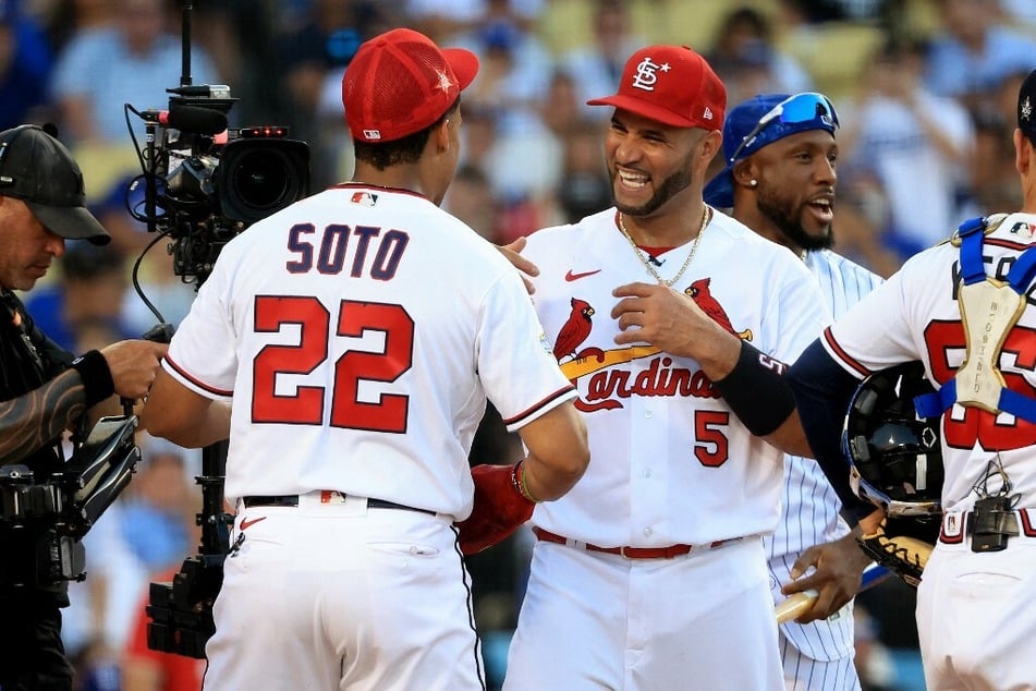 Albert Pujols of the St. Louis Cardinals celebrating with the 2022 Home Run Derby champion Juan Soto of the Washington Nationals.