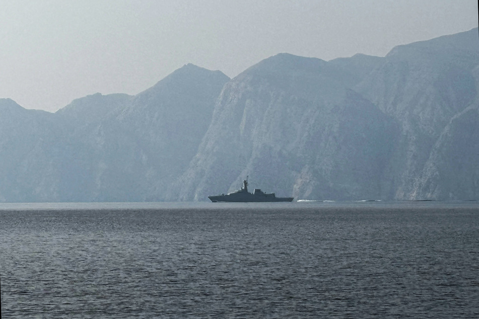A navy vessel is seen sailing in the Strait of Hormuz, a vital waterway through which much of the world's oil and gas passes on March 1, 2026.