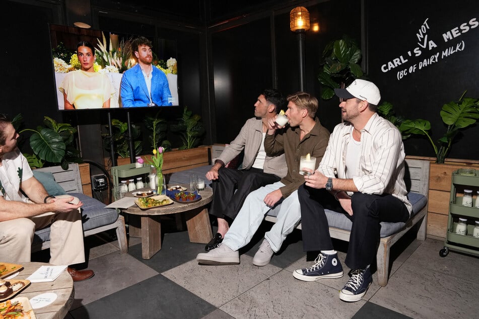 (From l to r) Carl Radke, Kyle Cooke, and Jesse Solomon look at a screen showing the Summer House reunion.