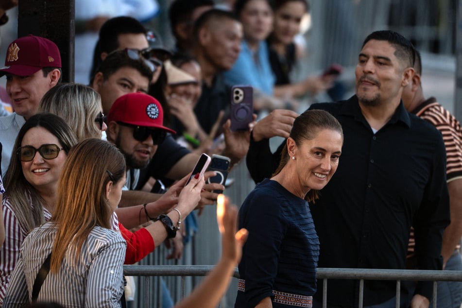 Mexican President Claudia Sheinbaum walks among supporters during the presentation of her second year government report on September 19. As she has celebrated her achievements, she's criticized Trump.
