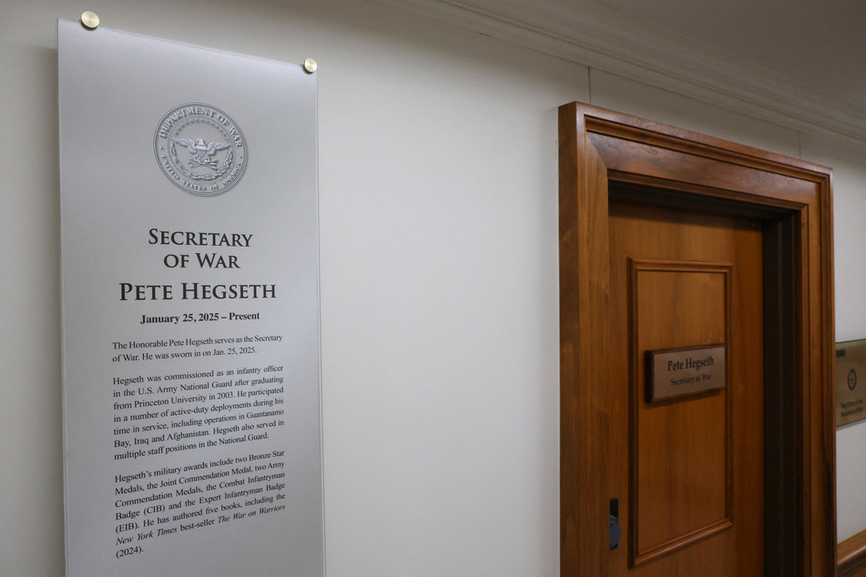 A plaque and a sign that read "Pete Hegseth – Secretary of War" hang at the Pentagon after President Donald Trump ordered the Department of Defense to be renamed as the "Department of War."