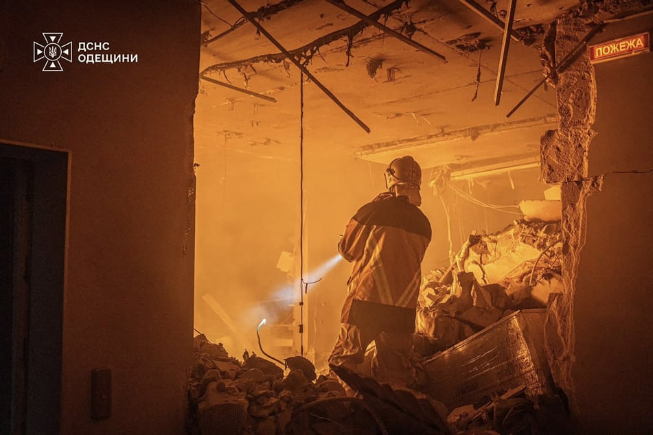 Firefighters work in a multistory residential building following a Russian aerial strike in Odesa, Ukraine, on September 17, 2026.