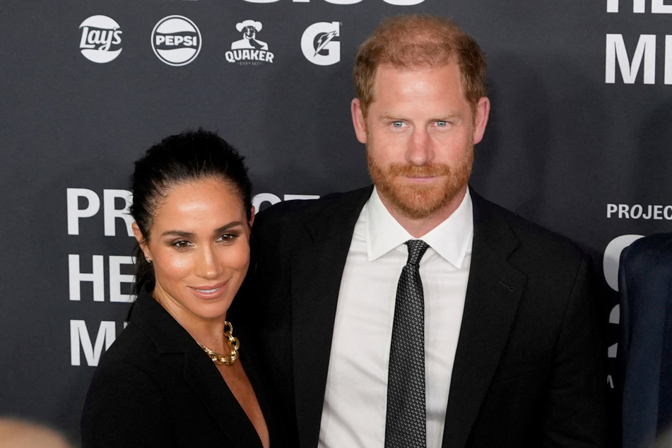 Meghan Markle (l.) and Prince Harry will continue their partnership with Netflix as producers on an upcoming adaptation of The Wedding Date.