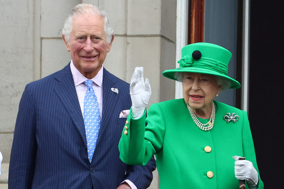 Queen Elizabeth II stands next to her son King Charles III (then known as Prince Charles) at the late monarch's platinum jubilee celebrations on June 5, 2022.