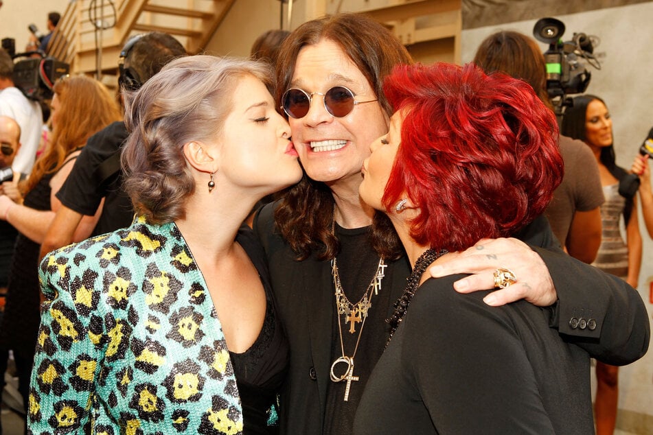 Kelly Osbourne (l) and her mom, Sharon, paid tribute to Ozzy Osbourne (c) on the first anniversary of his death.