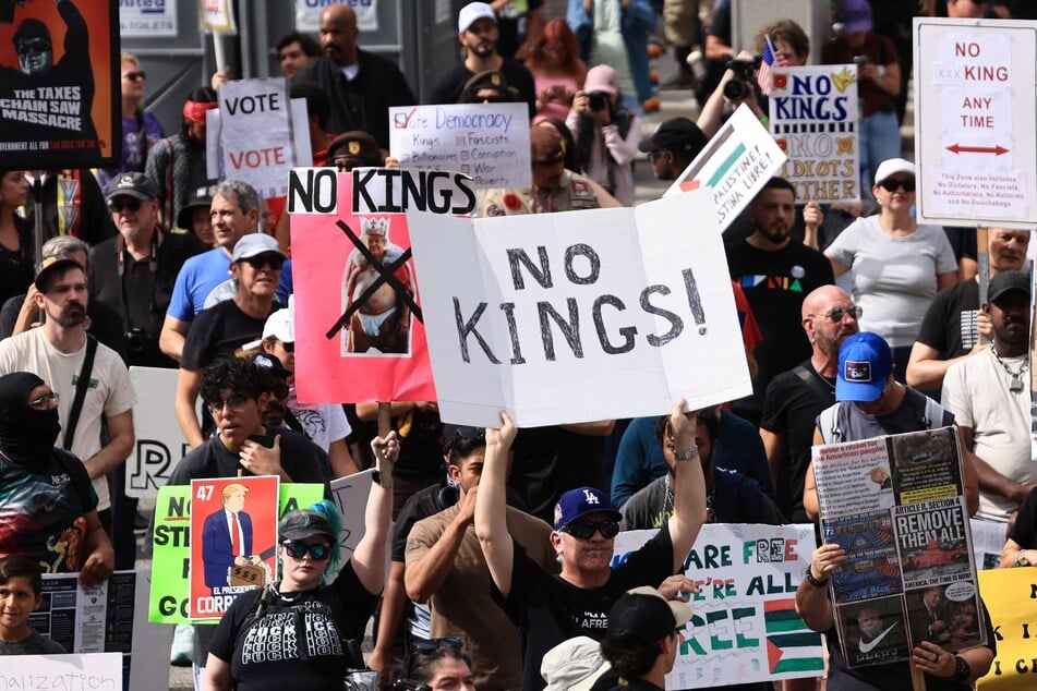 People participate in a No Kings: Vote Early demonstration in front of City Hall in Los Angeles, California, on October 17, 2026.