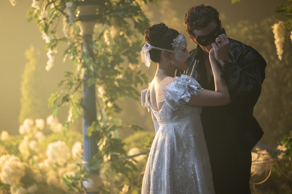 The two share their first kiss at a masquerade ball.