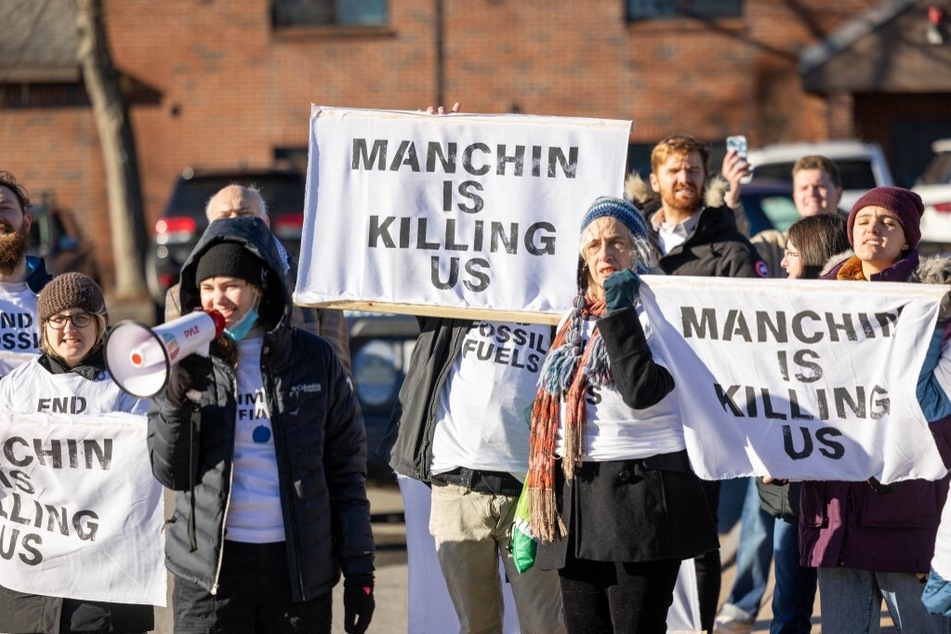 Climate Defiance activists rally outside Senator Joe Manchin's Politics & Eggs event in Manchester, New Hampshire, on January 12, 2024.