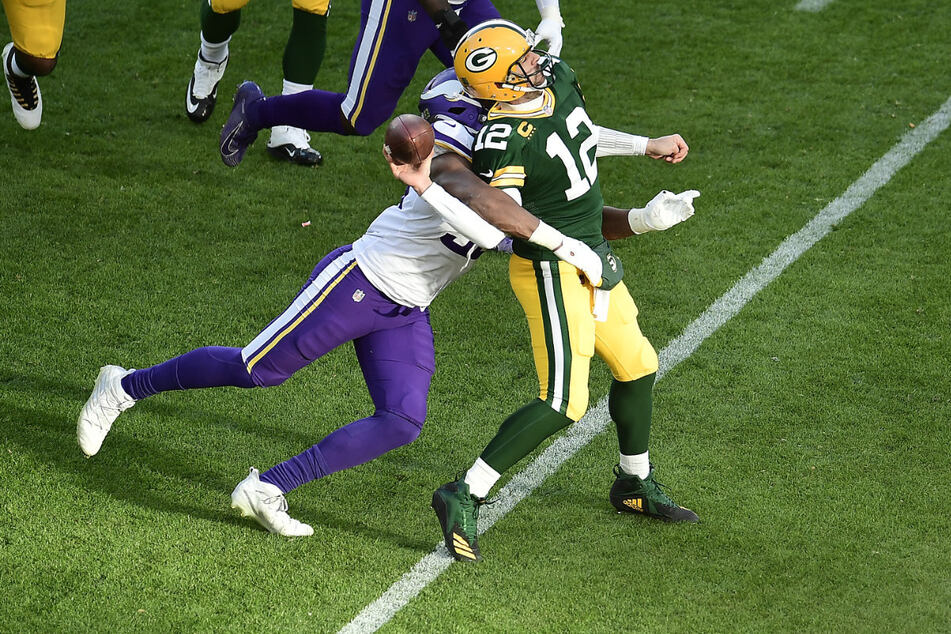 Green Bay Packers quarterback Aaron Rodgers (r) has also had to endure involuntary contact several times this season.