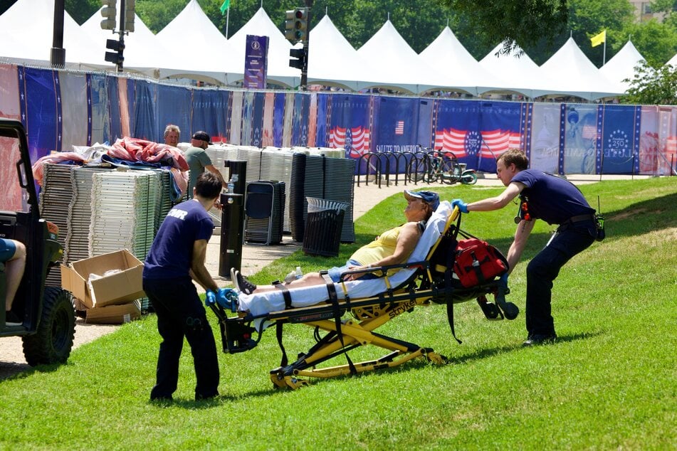 A person is helped by first responders amid extreme heat along the National Mall in Washington DC on July 3, 2026, as high temperatures grip the East Coast ahead of Independence Day celebrations.