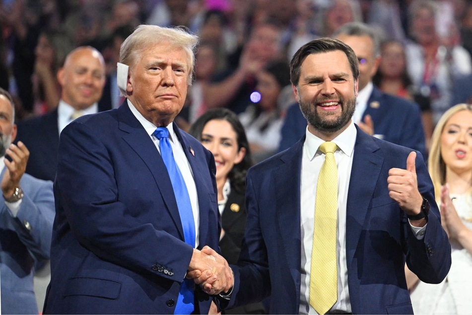 Donald Trump shaking hands with JD Vance during the second day of the 2024 Republican National Convention in Milwaukee, Wisconsin on July 16, 2024.