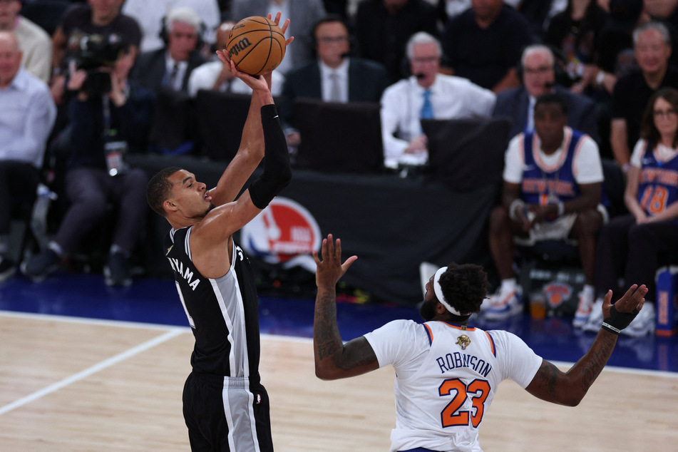San Antonio Spurs forward Victor Wembanyama shoots against New York Knicks center Mitchell Robinson in the fourth quarter during game three of the 2026 NBA Finals at Madison Square Garden.