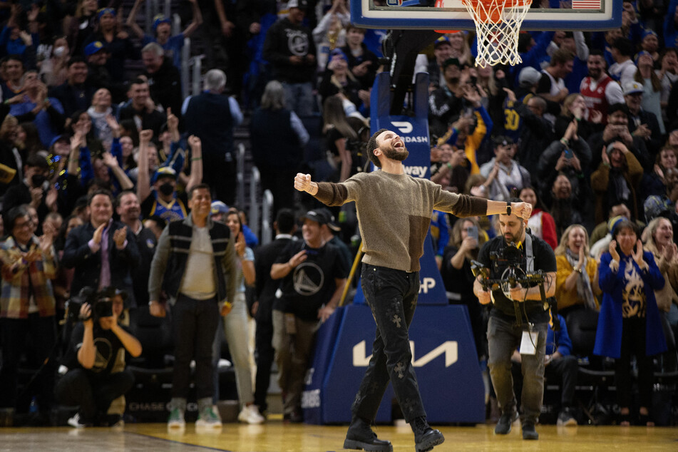 Golden State Warriors guard Stephen Curry, who is out with an injury, reacts after his teammates tied the score with the Atlanta Hawks in the closing seconds of the fourth quarter at Chase Center.