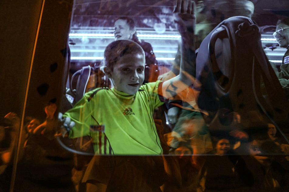 Tal Almog-Goldstein stands in a bus transporting him to an army base in southern Israel after being released by the Palestinian militant group Hamas on Sunday.