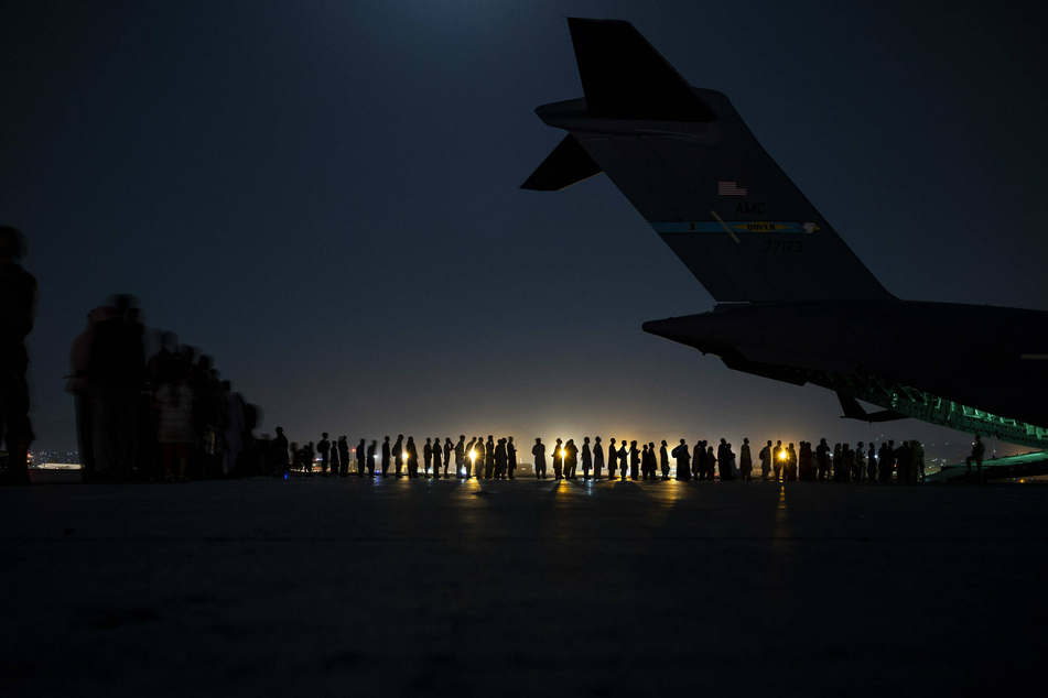 Afghan officer killed and others injured in attack on Kabul airport as chaos continues