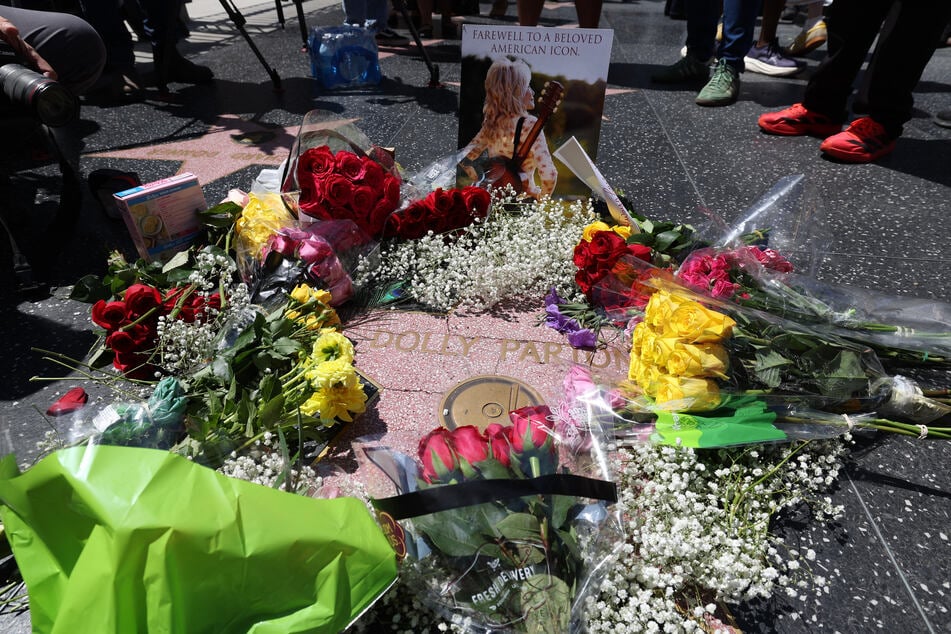 Flowers are seen on the Hollywood Walk of Fame Star of late US singer-songwriter Dolly Parton in the Hollywood neighborhood of Los Angeles on August 25, 2026.