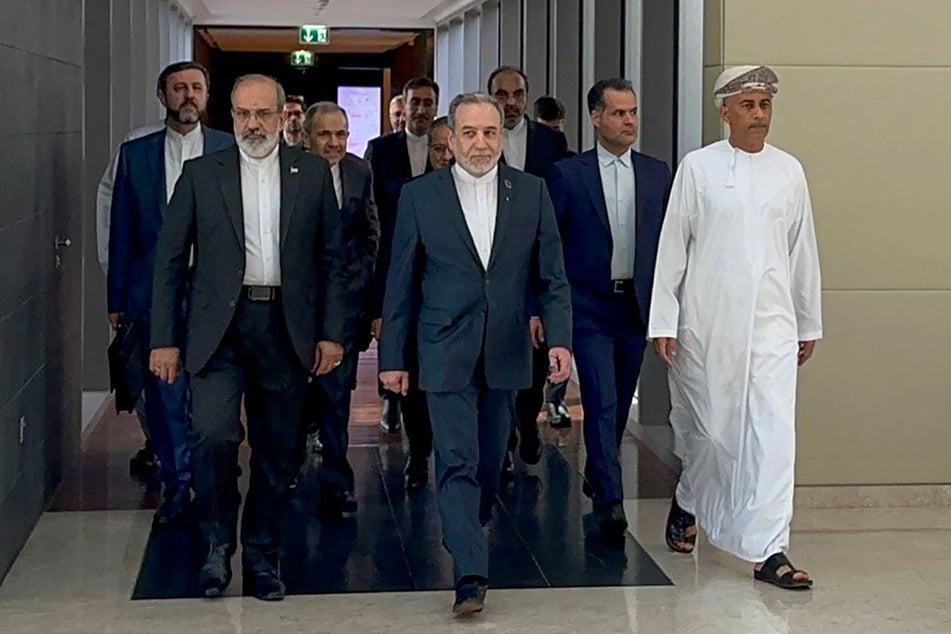 In this handout photo obtained from Iran’s foreign ministry delegation on Friday, Iran’s Foreign Minister Abbas Araghchi (c.) arrives for a meeting in Muscat.