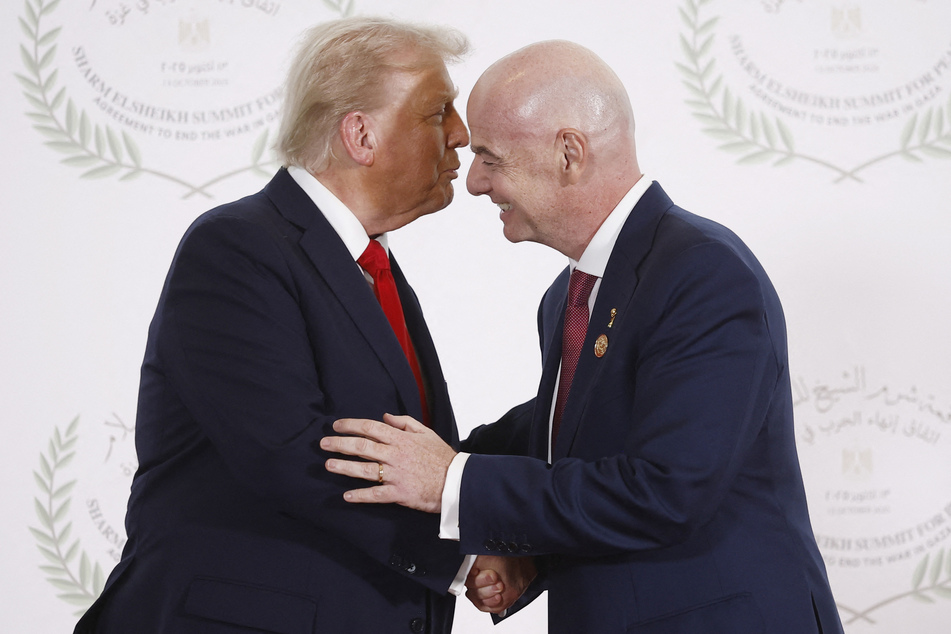 US President Donald Trump (l.) greets FIFA President Gianni Infantino during a summit on Gaza in Sharm el-Sheikh, Egypt, on October 13, 2025.