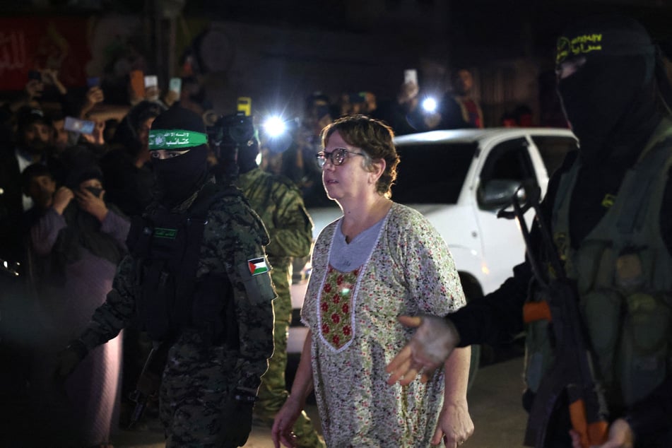 Hamas and Islamic Jihad fighters accompany a newly released hostage before handing her over to the Red Cross in Rafah on Tuesday.