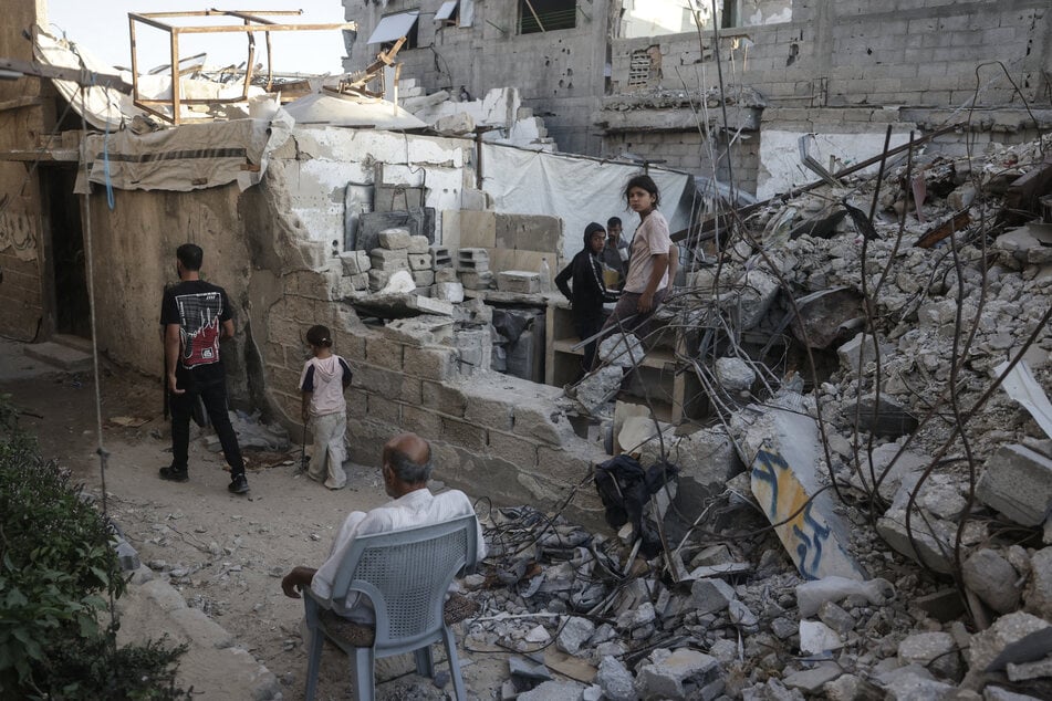 Displaced Palestinians gather atop rubble in the Gaza Strip on September 19, 2026. Gaza health officials say Israeli fire killed at least four people, including a child.