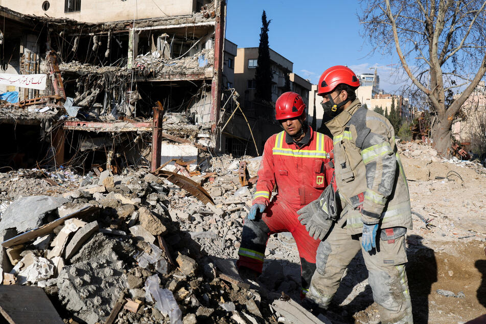 Members of a Red Crescent rescue team work at a building that was damaged by a strike in Tehran, Iran, on March 21, 2026.