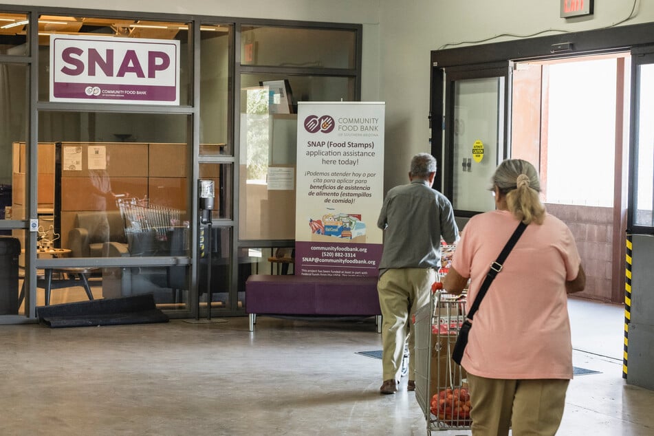 People depart after picking up food at the Community Food Bank of Southern Arizona in Tucson, Arizona, on October 17. The Trump administration's move to slash federal food assistance programs is weighing heavily on Arizona residents.