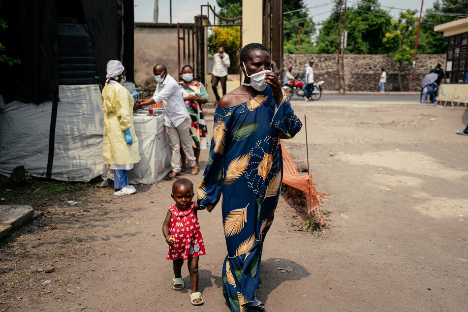 A woman wearing a mask as a preventive measure enters Kyeshero Hospital after passing a checkpoint for hand washing and health screening in Goma, DR Congo, on May 18, 2026.