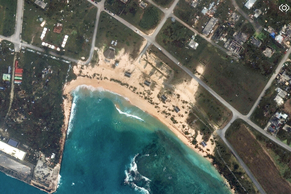 A satellite image taken and released on April 17, 2026, courtesy of Vantor shows major erosion at Kammer and Jones Beaches, as well as damaged roads and structures at San Jose village on the island of Tinian, after Typhoon Sinlaku made landfall on the Northern Mariana Islands.