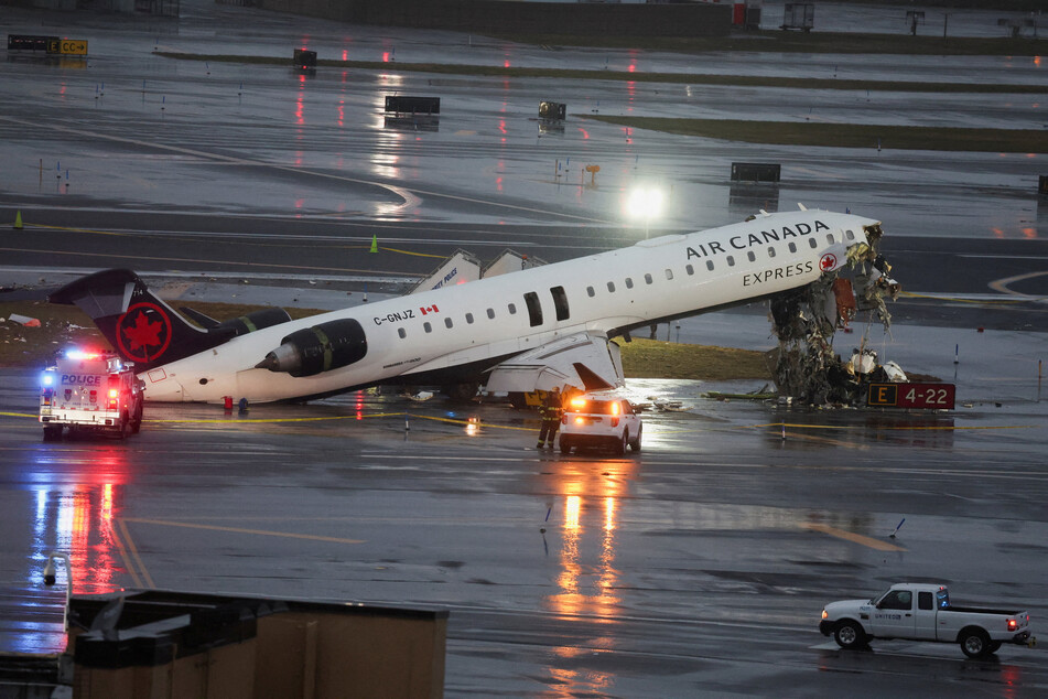 An Air Canada Express jet hit a fire truck on the runway of LaGuardia airport late on Sunday, killing at least two people.