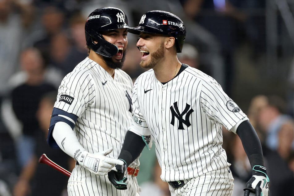 Cody Bellinger #35 (r.) of the New York Yankees reacts after a three-run home run against the Boston Red Sox during Game 2 of the AL Wild Card Series on Wednesday. The Yankees will now face Tampa Bay in the next round.