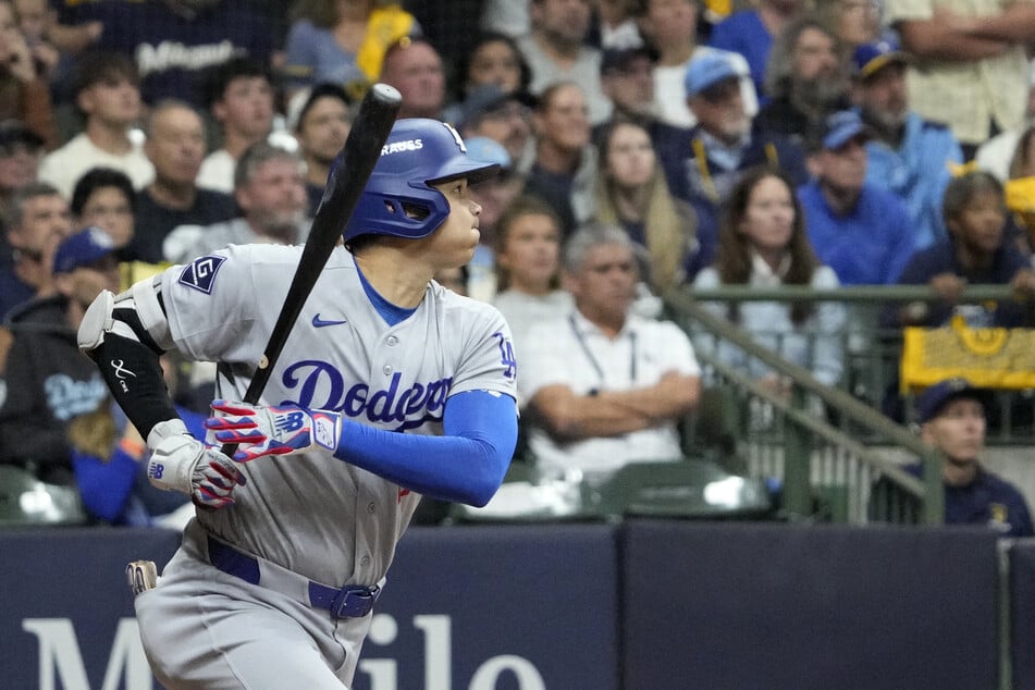 Shohei Ohtani singles against the Milwaukee Brewers during the sixth inning in game one of the NLCS.