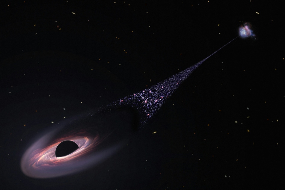 This is an artist's impression of a runaway supermassive black hole that was ejected from its host galaxy as a result of a tussle between it and two other black holes.