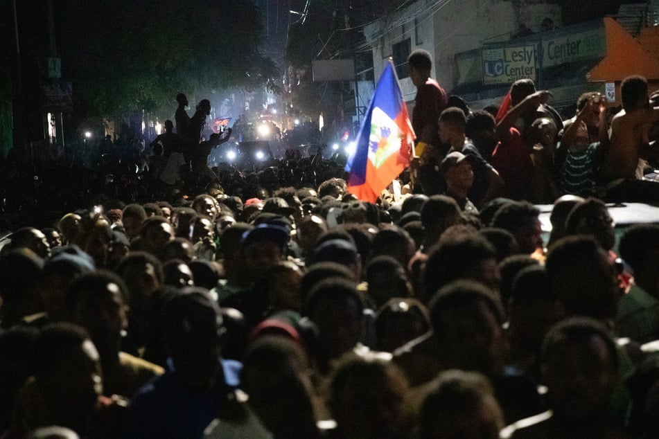 Fans cheer in the streets of Port-au-Prince on November 18, 2025, as Haiti celebrates its victory over Nicaragua and qualification for the 2026 FIFA World Cup.