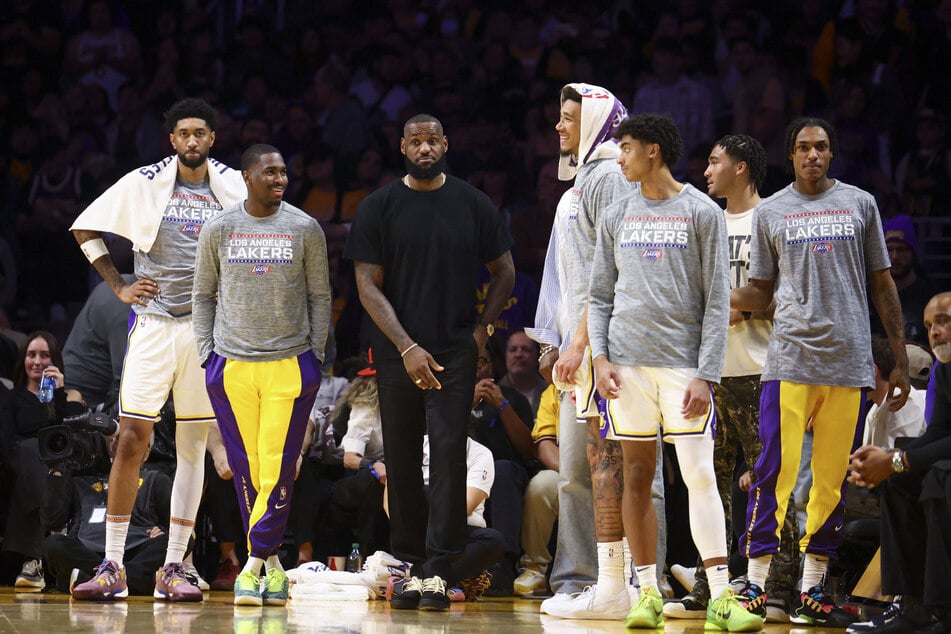 Los Angeles Lakers forward LeBron James and his teammates on the bench watch the game against the Portland Trail Blazers at Crypto.com Arena.