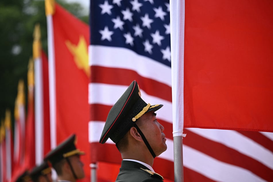 A Chinese People's Liberation Army honor guard stands with flags of the US and China in front of the Great Hall of the People ahead of a welcome ceremony for President Donald Trump in Beijing on May 14, 2026.