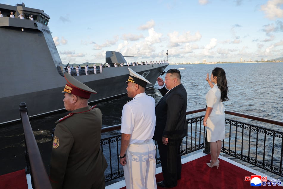 North Korean leader Kim Jong Un (c/r) salutes his country's Kang Kon destroyer during a commissioning ceremony at Wonsan Port on Monday.