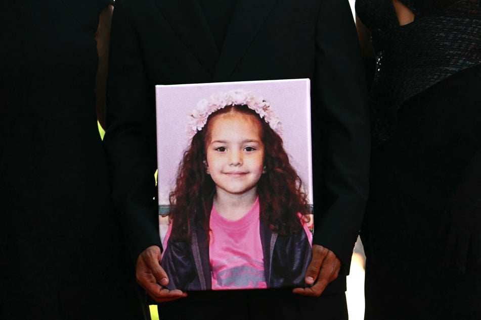 Guests hold a portrait of Hind Rajab during the red carpet for the movie The Voice of Hind Rajab, presented in competition at the 82nd International Venice Film Festival, on September 3, 2025.